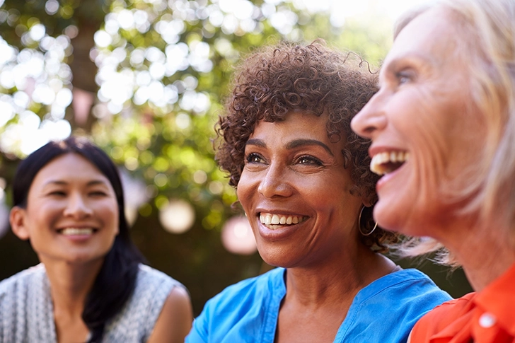 Diverse Group Of Friends Laughing In Backyard