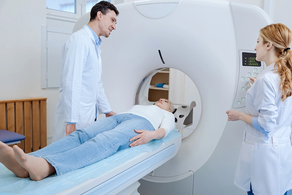 CT Technologists Discussing Medical Imaging Process With Female Patient