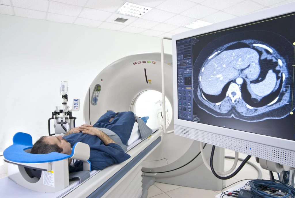 Male Patient Undergoes CT Scan With Monitor Of Live Results