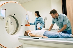 Nuclear Medicine Technologists Preparing Patient For PET CT Scan