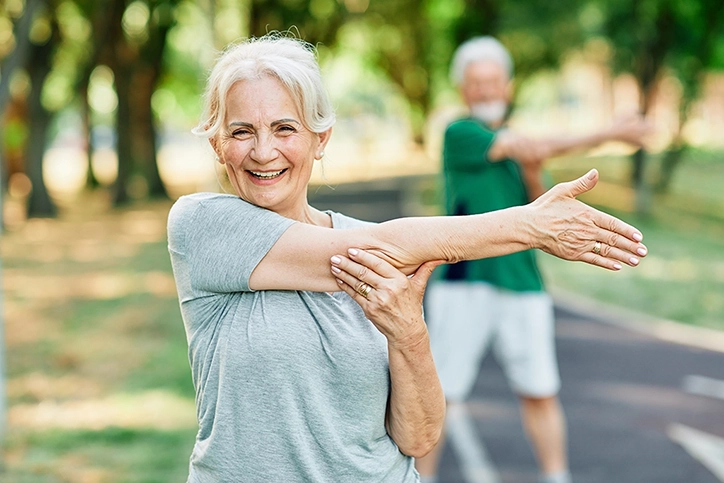 Older Woman Stretching Arms After Exercise