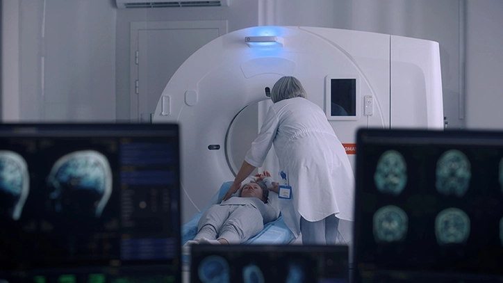 PET Technologist Positioning Patient Before PET CT Scan