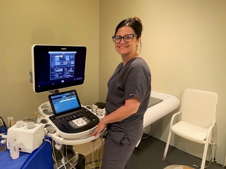 Ultrasound Technologist Smiling While Preparing For Appointment