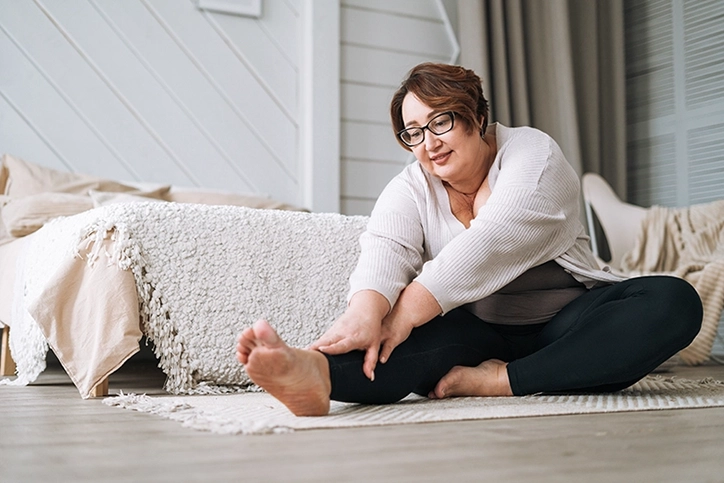 Woman Stretching In Her Home