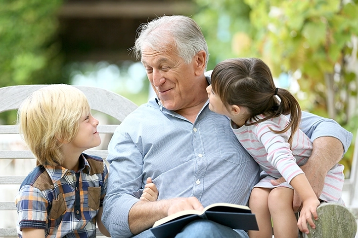 Grandfather Reading To Grandchildren