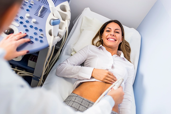 Young Woman Smiling During Her Pelvic Ultrasound