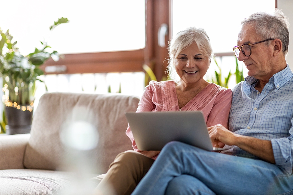 Couple Sitting On Their Couch Requesting Their Medical Records