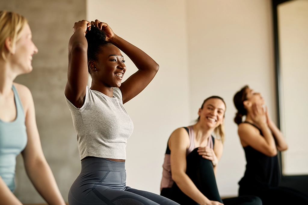 Woman Smiling With Friends During Yoga Session